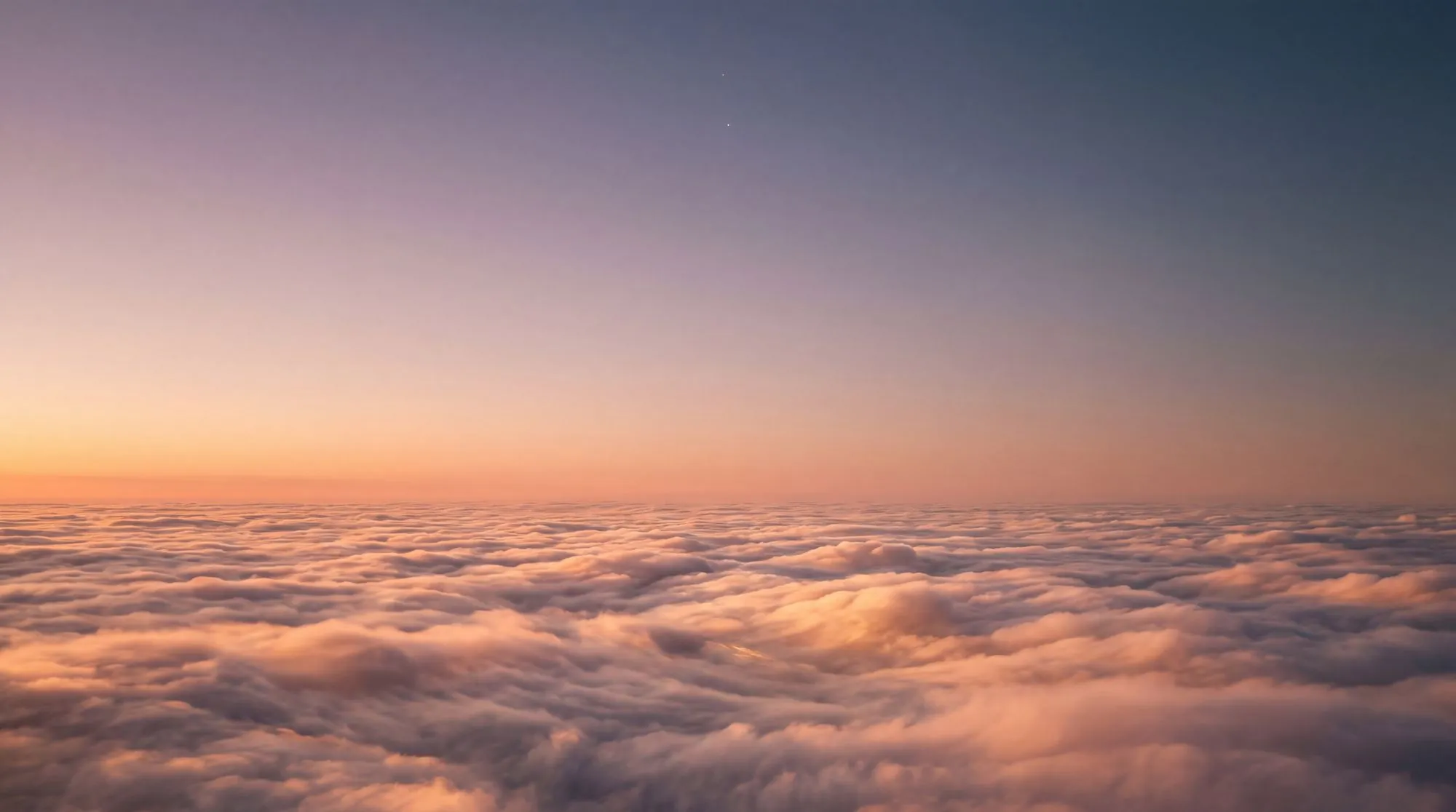 A sea of clouds glowing at dusk